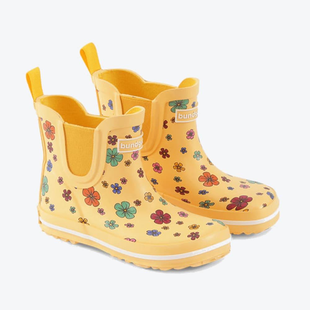 Die Bundgaard Gummistiefel in Größe 32, Modell Charly Low Cosmos Flower, zeigen sich aus einem Winkel von 330 Grad und begeistern mit ihrem lebendigen Gelb und dem zauberhaften Blumenmuster.